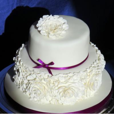 Soft icing folds create a beautiful rose inspired decoration.